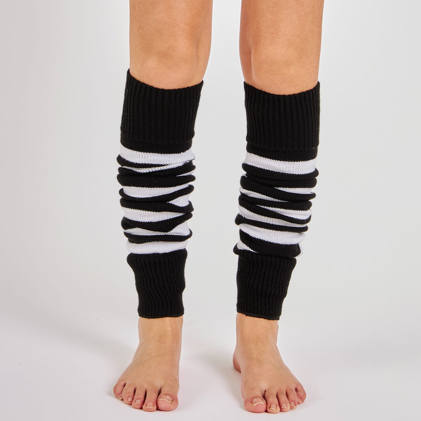 Woman wearing Mysocks black and white striped 100% acrylic leg warmers