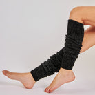 Women's black glitter speckled knit leg warmers worn over bare legs