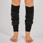 Women's black glitter speckled knit leg warmers worn over bare legs