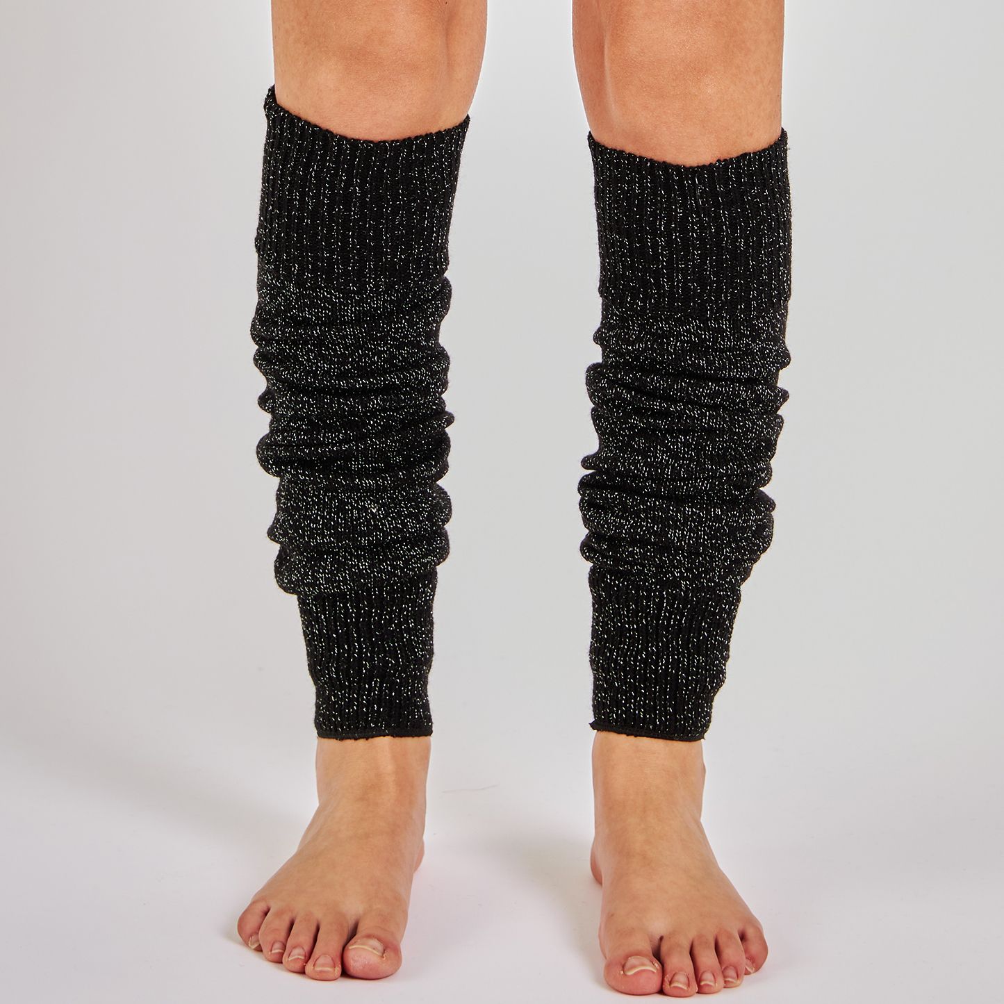 Women's black glitter speckled knit leg warmers worn over bare legs