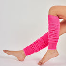 Woman's legs wearing neon pink ribbed knit leg warmers for dance and parties