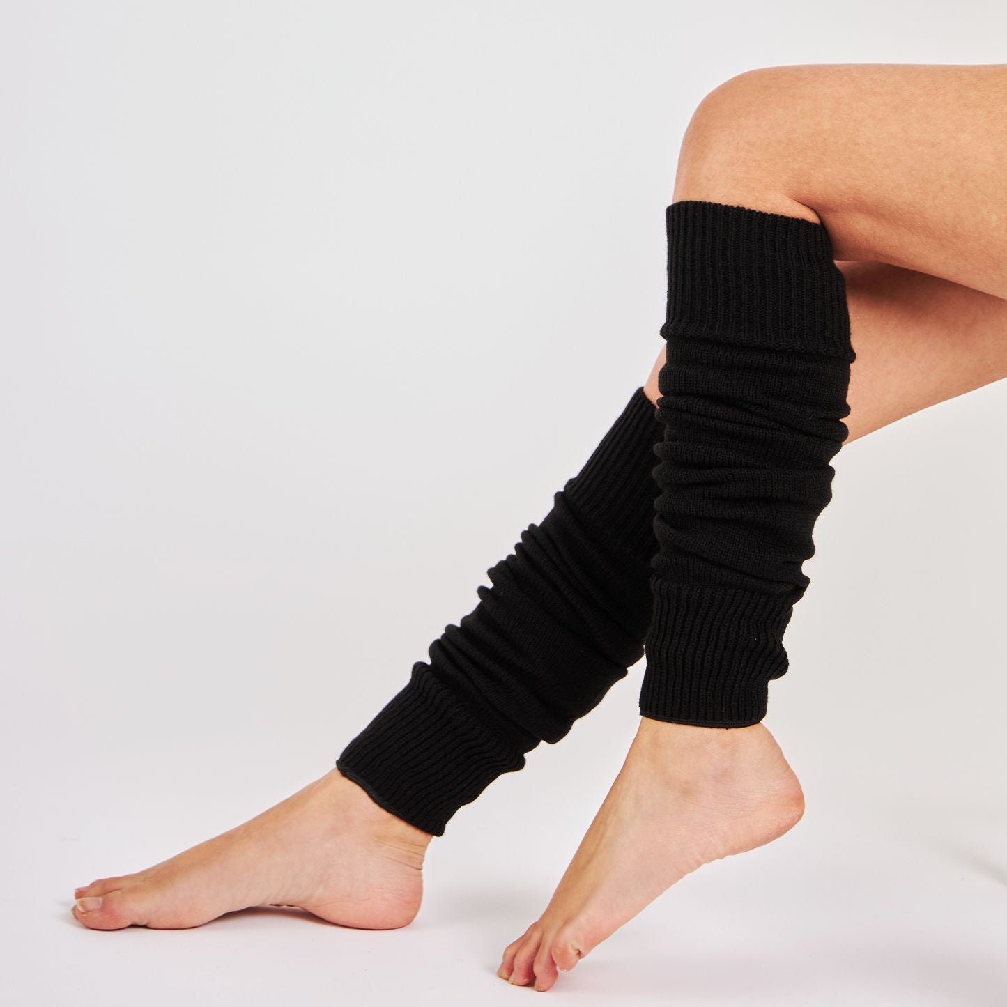 Woman wearing Mysocks plain black 100% acrylic leg warmers